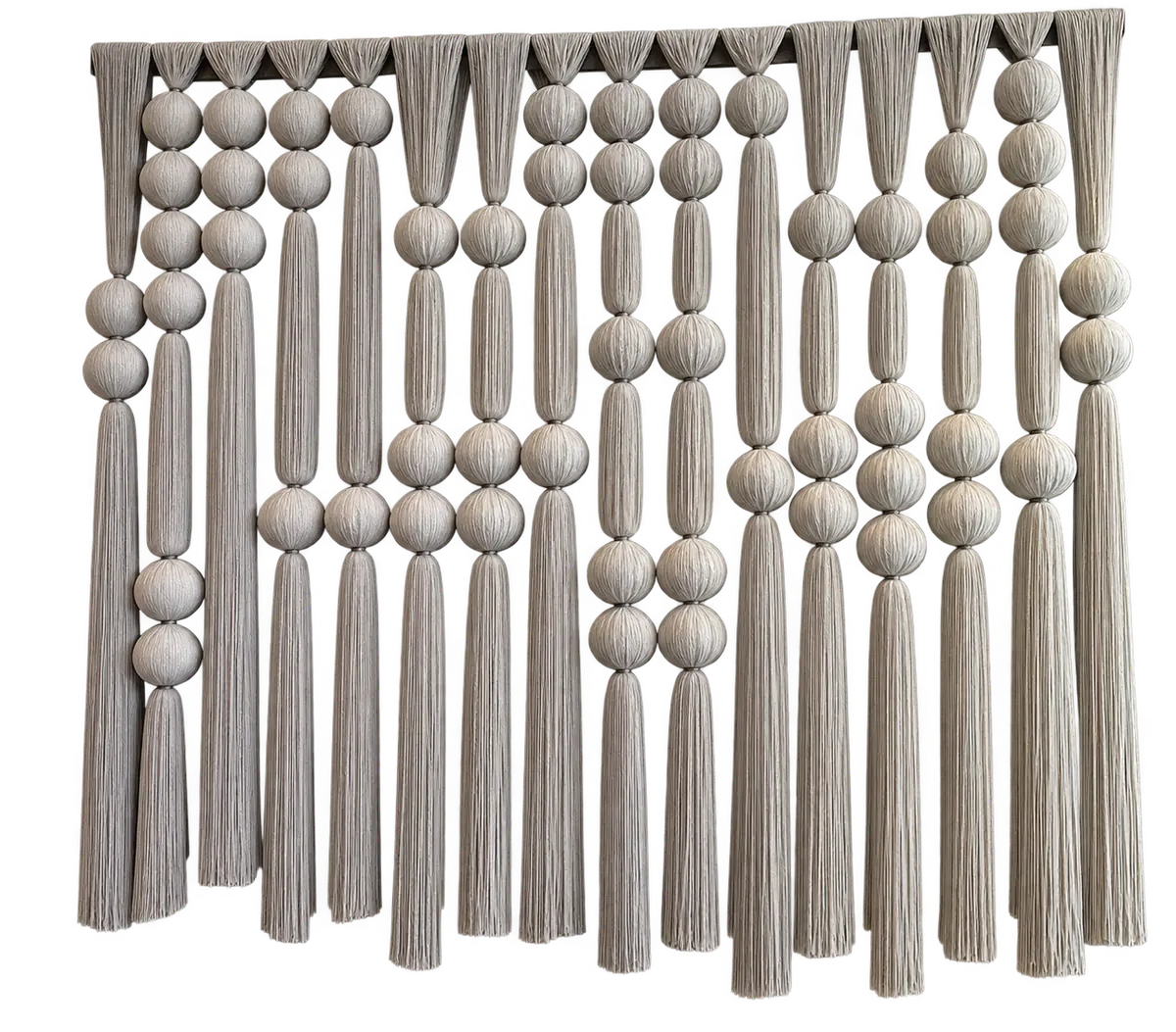 A macramé panel of round ball knots in rows above a long combed fringe